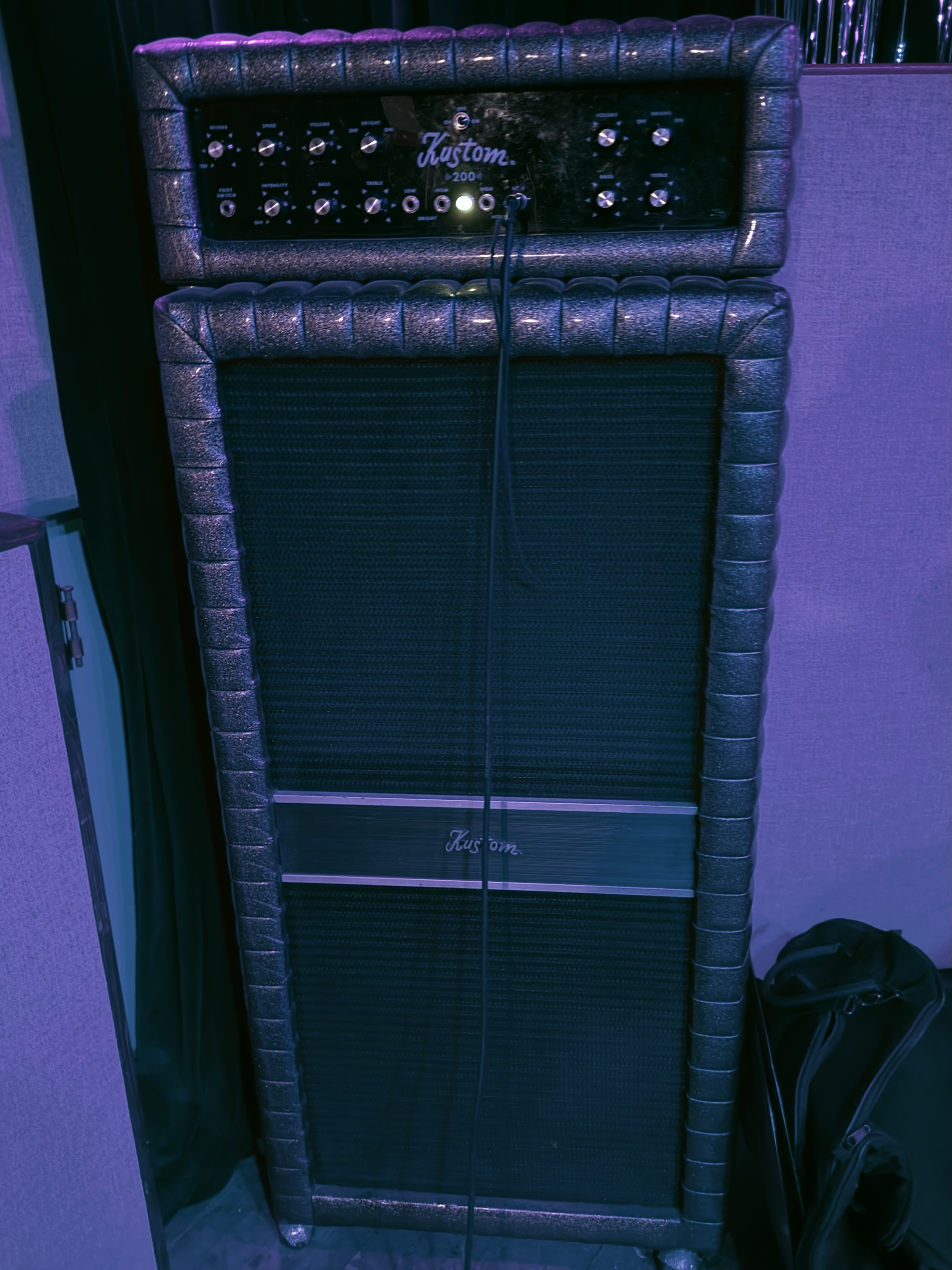 A vintage Kustom bass amplifier stack with black tuck-and-roll covering